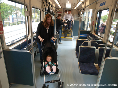 Mother with a child and stroller aboard Link