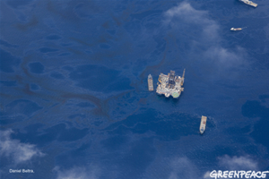 Surface ships making their way through oily, polluted ocean