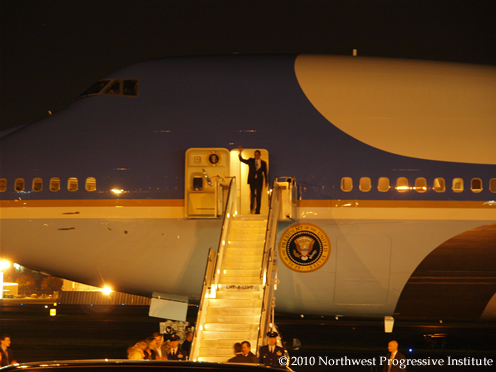 President Barack Obama waves as he exits Air Force One