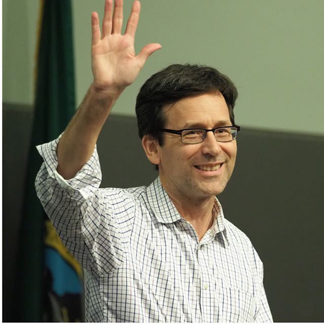 Attorney General Bob Ferguson waves to the crows after getting a final, booming standing ovation from attendees of the 2017 Washington State Democratic Crab Feed