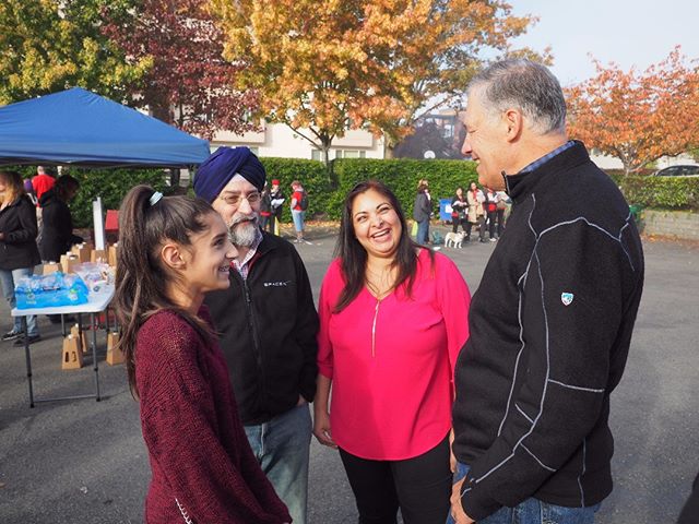 Governor Jay Inslee shares a laugh with Democratic State Senate candidate Manka Dhingra and her family at a Saturday canvassing kickoff