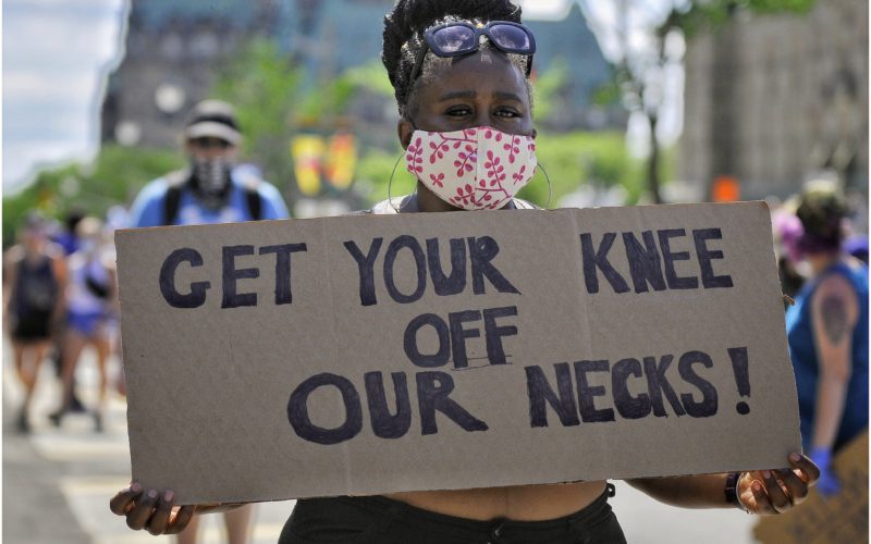 Get your knee off our necks: A sign protesting the murder of George Floyd