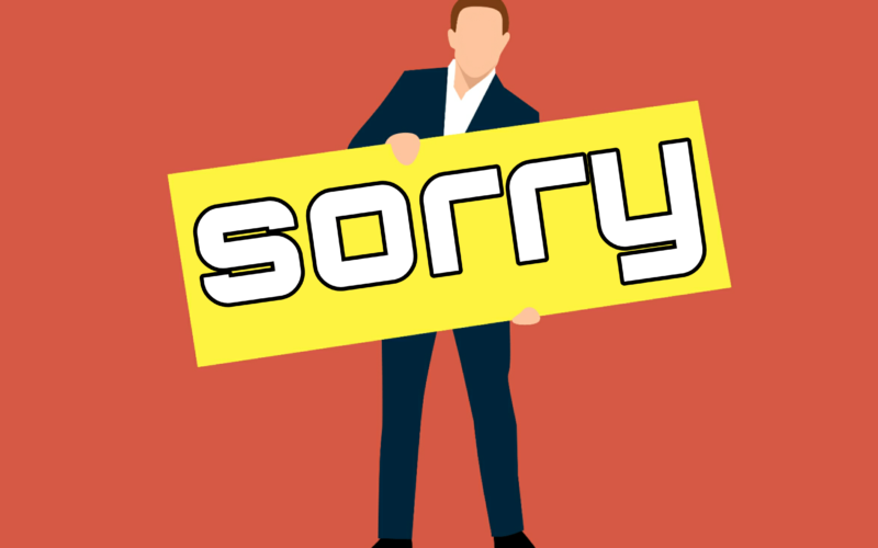 Generic corporate figure holding a sign saying Sorry