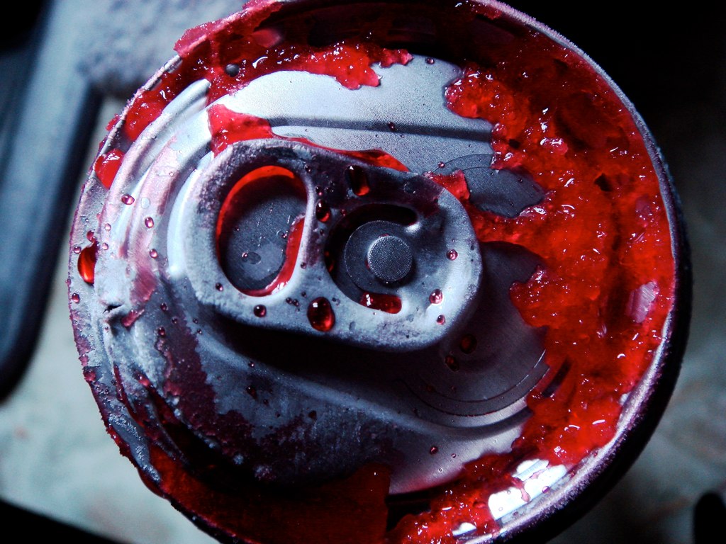 A gusher of red from a soda can