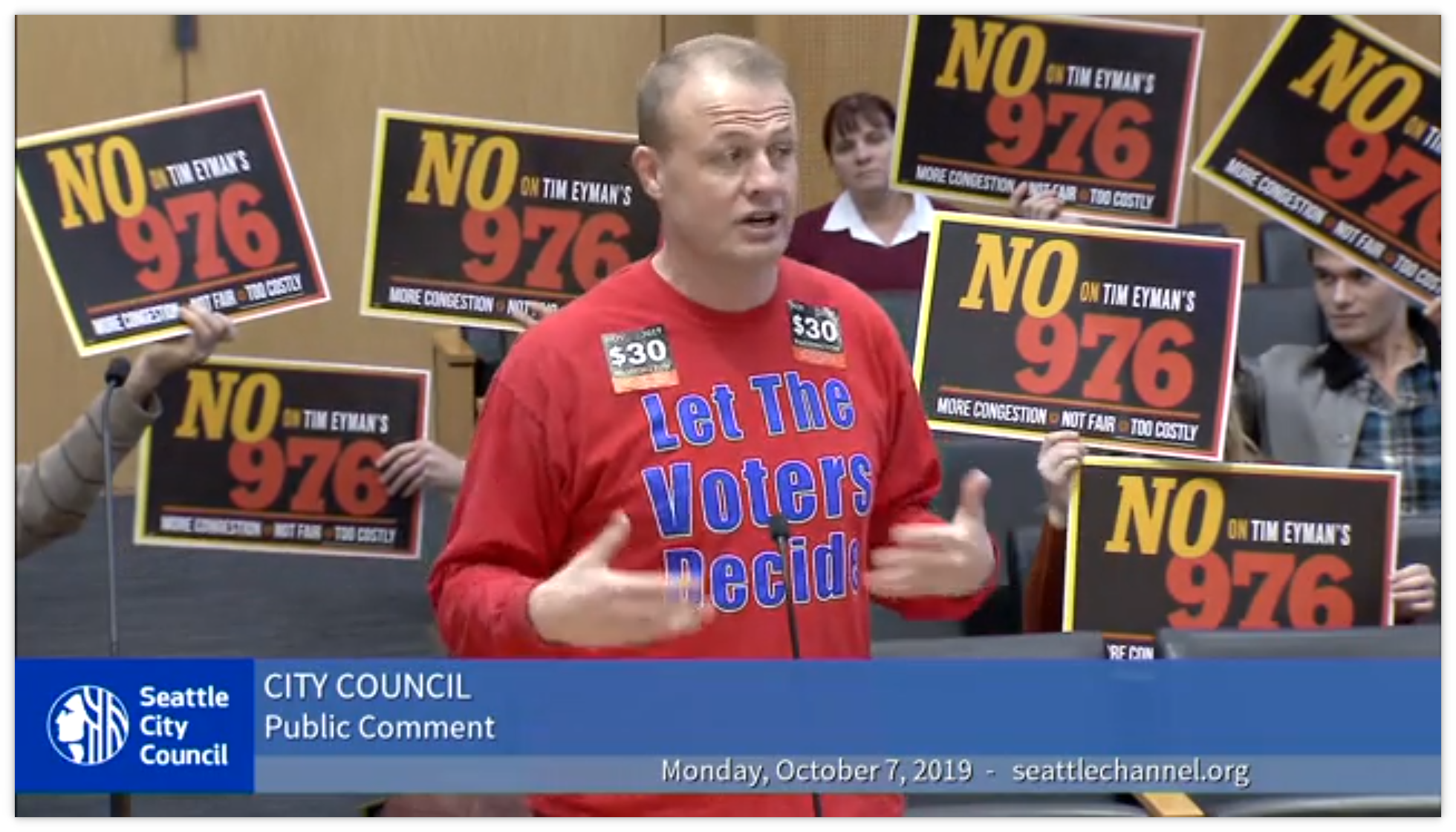Tim Eyman surrounded by NO on I-976 signs