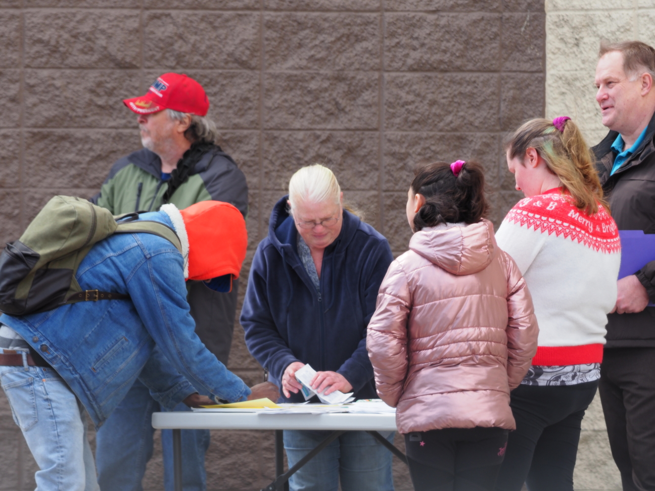 People congregating around a petition table