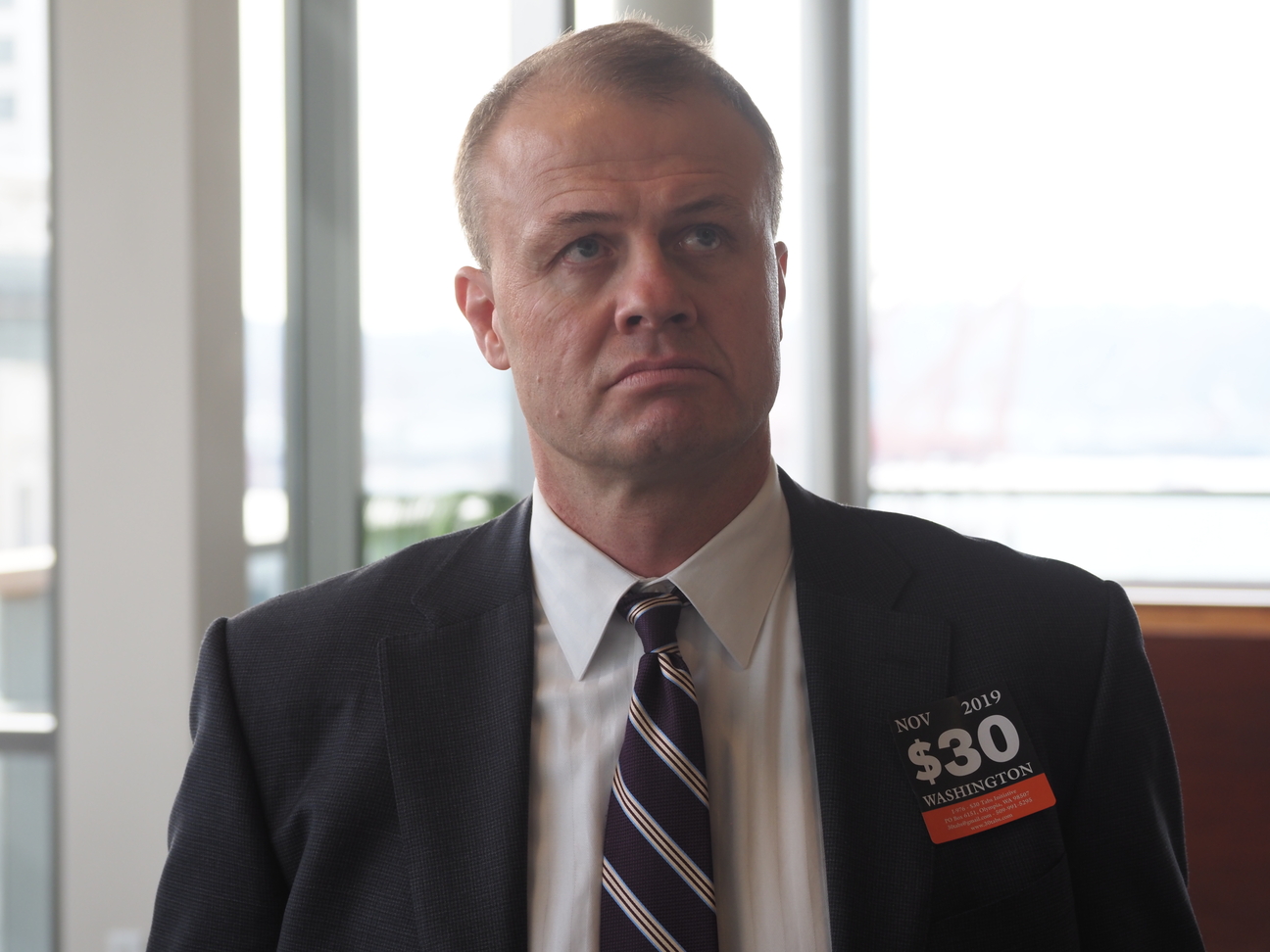 Tim Eyman listens uncomfortably during a confrontation with his opponents