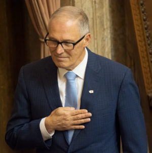 Governor Inslee listens to the national anthem before State of the State