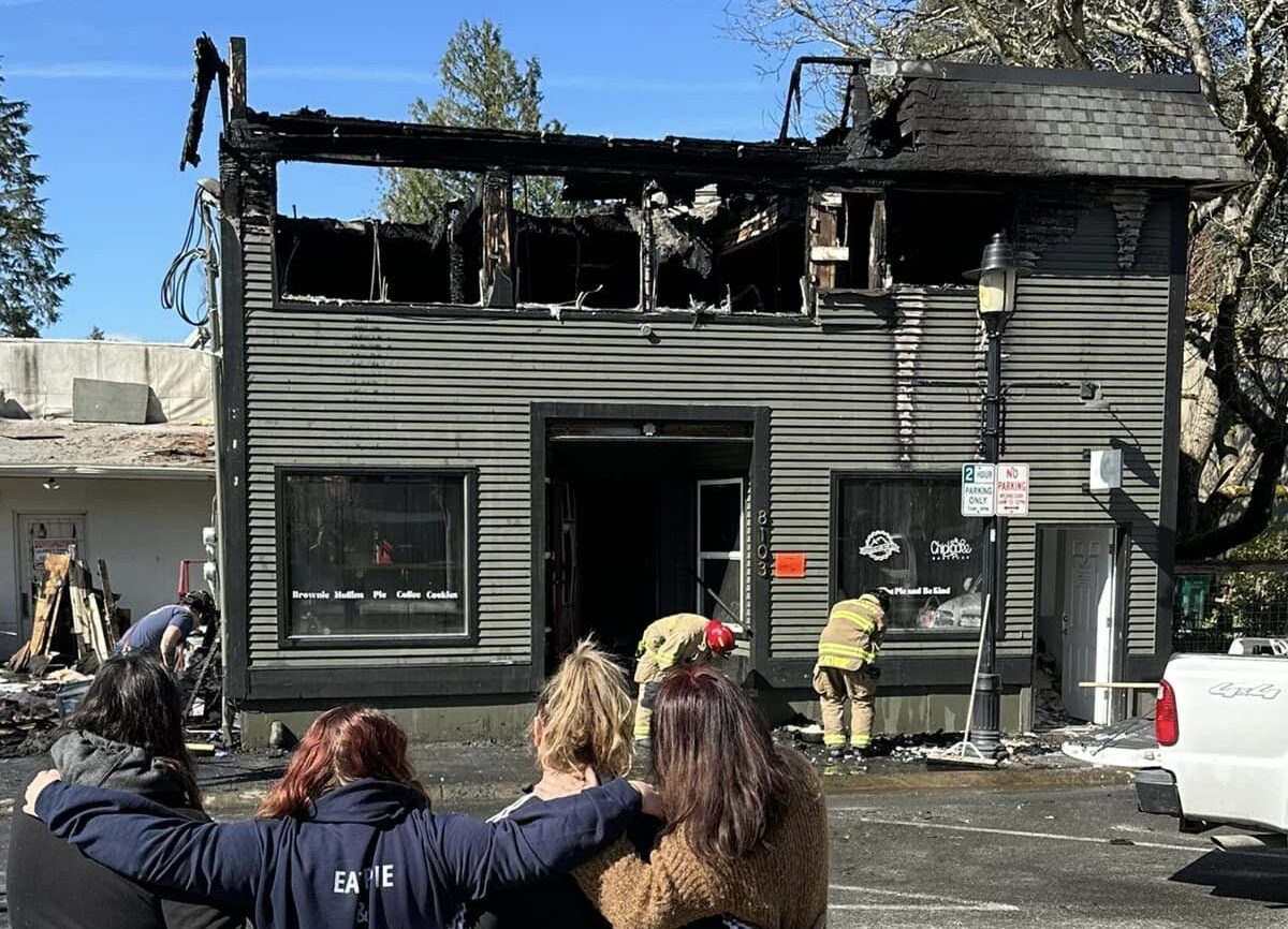 Firefighters clean up from a devastating blaze in downtown Snoqualmie